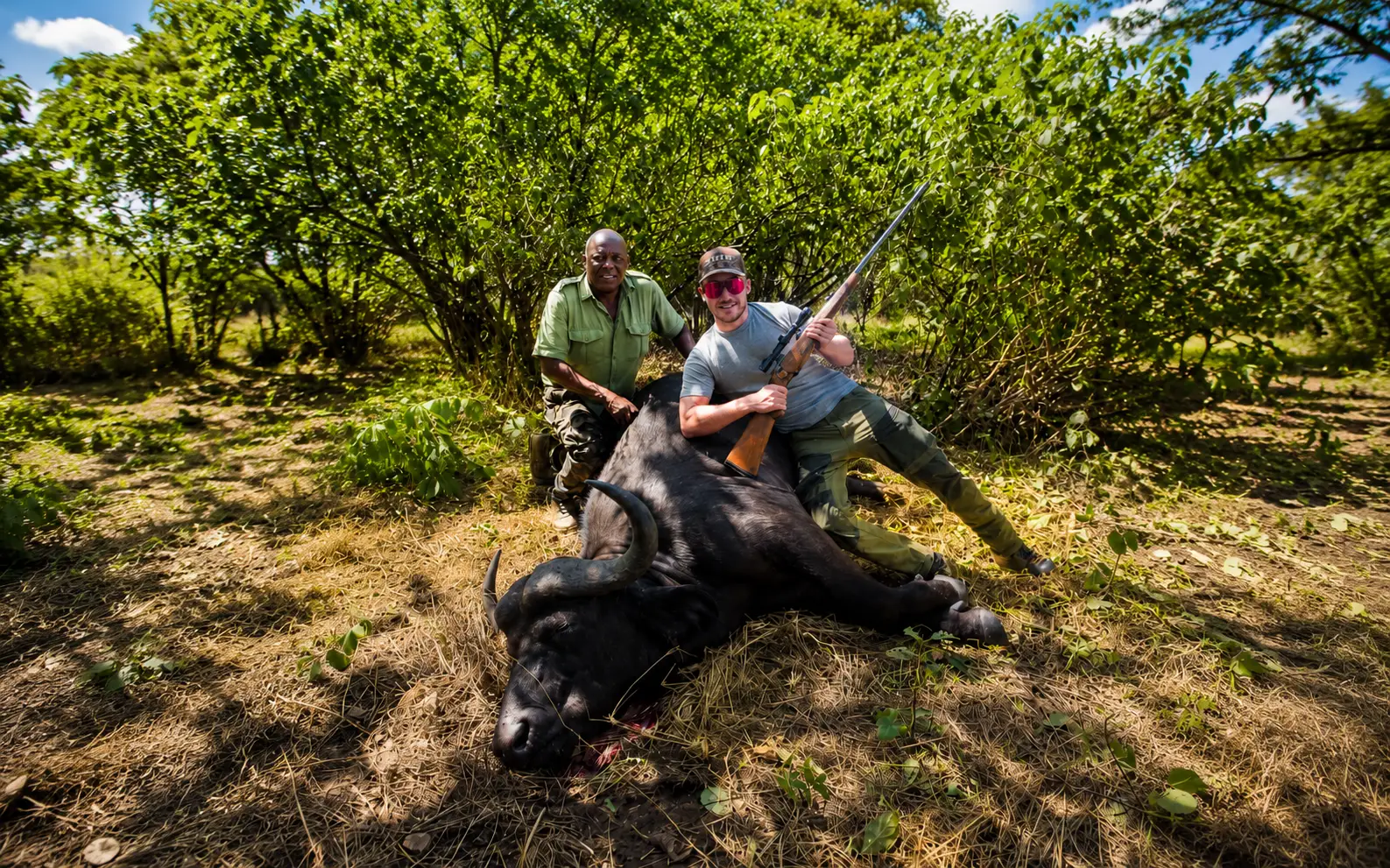 Client and professional guide posing with a buffalo trophy in Zimbabwe