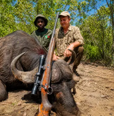 Hunter and guide posing beside a buffalo trophy during a Zimbabwe safari